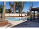 Private in-ground pool area with palm trees and ample space, ideal for outdoor relaxation and enjoyment at 1340 Lucky St, Las Vegas, NV 89104