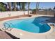 Refreshing in-ground pool with a spa feature, set within a private yard with lush palm trees at 1340 Lucky St, Las Vegas, NV 89104