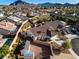 Aerial view of a single-Gathering home with a pool, patio, separate storage building, and desert landscaping at 159 Coastal Pier Ct, Henderson, NV 89002