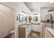 Modern bathroom featuring double sinks, quartz countertops, and a walk-in shower at 159 Coastal Pier Ct, Henderson, NV 89002