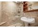 Bathroom with glass shower, tiled walls, and decorative wood shelving at 159 Coastal Pier Ct, Henderson, NV 89002