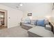 Bright bedroom featuring a pullout sofa, plush carpet, and a view into the bathroom at 159 Coastal Pier Ct, Henderson, NV 89002