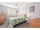 Cozy bedroom with a bed, wooden dresser, and window with light-blocking shutters at 159 Coastal Pier Ct, Henderson, NV 89002