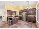 Open kitchen with an island, stainless steel appliances, and plentiful counter space at 159 Coastal Pier Ct, Henderson, NV 89002