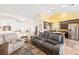 Inviting living space adjacent to the kitchen features comfortable seating and an open floor plan at 159 Coastal Pier Ct, Henderson, NV 89002