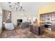 Open living area with tiled floors, comfortable seating, and a kitchen island at 159 Coastal Pier Ct, Henderson, NV 89002