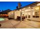 Covered patio with a full dining set and a view of the manicured yard and sparkling pool at 159 Coastal Pier Ct, Henderson, NV 89002