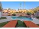 Backyard pool oasis with a rock waterfall feature and lounge chairs at 159 Coastal Pier Ct, Henderson, NV 89002
