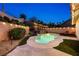 Backyard pool features unique shape, lush landscaping, and waterfall feature with patio furniture at 159 Coastal Pier Ct, Henderson, NV 89002