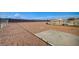 This property has a spacious backyard with gravel and chain link fence at 1608 June Ave, North Las Vegas, NV 89032