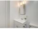 This bathroom has a white sink and vanity with a modern mirror and lighting at 1608 June Ave, North Las Vegas, NV 89032