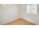 Bedroom featuring wood-look floors and a barred window for security at 1608 June Ave, North Las Vegas, NV 89032