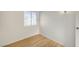 This bedroom has hardwood floors, a window with security bars, and white walls at 1608 June Ave, North Las Vegas, NV 89032