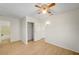 A neutral bedroom features a ceiling fan, closet, and wood-look floors at 1608 June Ave, North Las Vegas, NV 89032