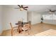 Dining area with laminate floors, a ceiling fan, and views into the living room at 1608 June Ave, North Las Vegas, NV 89032