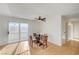 Dining area with wood-look flooring, modern ceiling fan, and natural light from glass door at 1608 June Ave, North Las Vegas, NV 89032