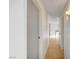 Hallway that leads to a kitchen with wood-look floors and white walls at 1608 June Ave, North Las Vegas, NV 89032