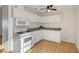 Compact kitchen features white cabinets, granite countertops, and modern appliances at 1608 June Ave, North Las Vegas, NV 89032