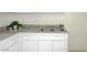 Close up on kitchen sink, granite counters, and white cabinets at 1608 June Ave, North Las Vegas, NV 89032