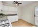 Updated kitchen with white cabinets, granite counters and wood-look floors at 1608 June Ave, North Las Vegas, NV 89032