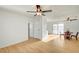 Open-concept living room and dining area with ceiling fans and wood laminate flooring at 1608 June Ave, North Las Vegas, NV 89032