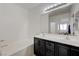 Bathroom featuring double sink vanity, soaking tub, and modern lighting at 201 Crown Imperial St, Henderson, NV 89074