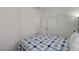 Bright bedroom featuring closet, interior door, and bed with patterned bedding at 201 Crown Imperial St, Henderson, NV 89074