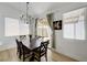 Charming dining area with modern light fixture and sliding glass door access to patio at 201 Crown Imperial St, Henderson, NV 89074