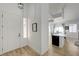 Bright home entryway with hardwood floors leads to the kitchen with island at 201 Crown Imperial St, Henderson, NV 89074