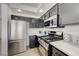 Bright kitchen featuring stainless steel appliances, black cabinets, and light countertops at 201 Crown Imperial St, Henderson, NV 89074