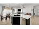 Open-concept living room featuring kitchen island, dining area, and fireplace with modern finishes at 201 Crown Imperial St, Henderson, NV 89074