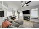 Inviting living room with hardwood floors, grey sofa, tiled fireplace, and dining area at 201 Crown Imperial St, Henderson, NV 89074