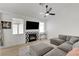 Well-lit living room with hardwood floors, grey sofa, tiled fireplace, and tv at 201 Crown Imperial St, Henderson, NV 89074