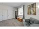 Comfortable living room featuring couch, storage shelving, and window at 201 Crown Imperial St, Henderson, NV 89074