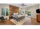 Stylish bedroom with a wood accent wall, neutral tones, and sliding glass doors to a private outdoor space at 21 Grand Masters Dr, Las Vegas, NV 89141