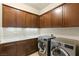 This laundry room has front loading washer and dryer, counter space, and plenty of cabinets at 21 Grand Masters Dr, Las Vegas, NV 89141