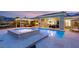 Stunning backyard with a pool, hot tub, built-in grill, covered patio, and ample space for entertaining guests at 21 Grand Masters Dr, Las Vegas, NV 89141