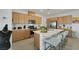 Bright kitchen featuring stainless steel appliances, light wood cabinets, and a spacious island with seating at 2261 Cold Canyon Ave, North Las Vegas, NV 89086