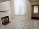 Bright living room featuring a fireplace and neutral tile flooring at 2471 Old Forge Ln # 105, Las Vegas, NV 89121