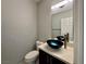 Small bathroom featuring modern vanity with vessel sink, neutral walls, and white toilet at 248 Crystal Rose Ct, Las Vegas, NV 89106