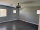 Bedroom with grey walls, hardwood floors, and natural light from bright windows at 248 Crystal Rose Ct, Las Vegas, NV 89106