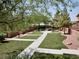 Well-maintained community area with manicured lawns, walking paths, trees, and garden beds at 248 Crystal Rose Ct, Las Vegas, NV 89106