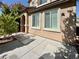 Home exterior with concrete patio, manicured landscaping, and light-colored stucco at 248 Crystal Rose Ct, Las Vegas, NV 89106