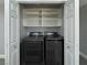 Convenient laundry closet featuring a modern washer and dryer set with built-in shelving at 248 Crystal Rose Ct, Las Vegas, NV 89106