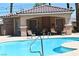 Community pool with lounge chairs, tables, and a shower/changing area nearby at 248 Crystal Rose Ct, Las Vegas, NV 89106