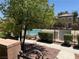 Community pool area featuring a secure fence and ample seating for relaxation at 248 Crystal Rose Ct, Las Vegas, NV 89106