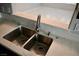 Close-up of a modern kitchen sink with stainless steel fixtures and light countertops at 248 Crystal Rose Ct, Las Vegas, NV 89106