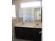 Bathroom with dual sink vanity, large mirror, and white countertop at 254 Horizon Pointe Cir, Henderson, NV 89012