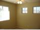 A bedroom with neutral walls, carpet flooring, and multiple windows at 254 Horizon Pointe Cir, Henderson, NV 89012