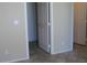 Hallway featuring a doorway, neutral wall color, and tile flooring at 254 Horizon Pointe Cir, Henderson, NV 89012